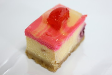 piece of cherry cake on white isolated background.