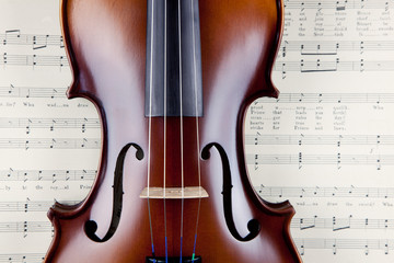 Violin on open old sheet music book