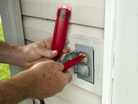 Electrician Testing A Outside Electrical Outlet