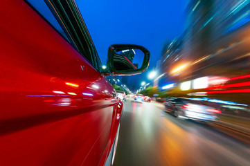 A car driving on a motorway at high speeds, overtaking other cars