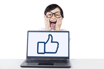 Girl screaming with laptop on the table