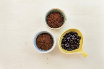 Coffee powder and coffee bean on wood background