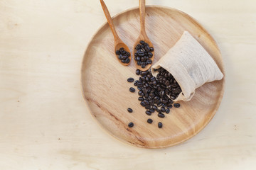 Roasted coffee bean on wooden plate