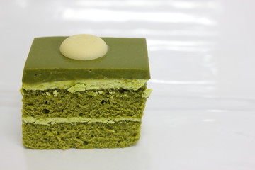 Green tea layer cake on the table.