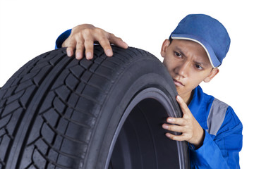 Technician examining a tire