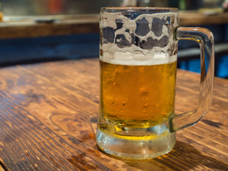 Half glass of beer on table