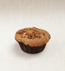 Closeup coffee raisin muffin on canvas background