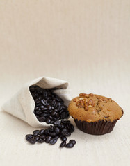 Closeup coffee raisin muffin with coffee beans 