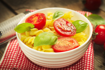 Traditional italian pasta with tmatoes and fresh basil. Selective focus