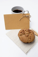 Coffee raisin muffin with coffee and yellow card