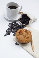 Coffee raisin muffin with coffee on background