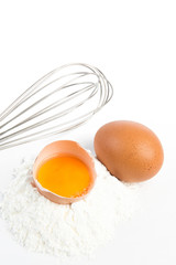 pile of flour and eggs on white