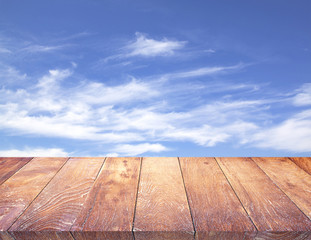 Wood table top on & sky background