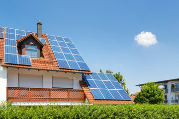 House with garden and solar panels on the roof