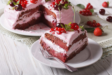 The cut piece of berry cake with pink cream