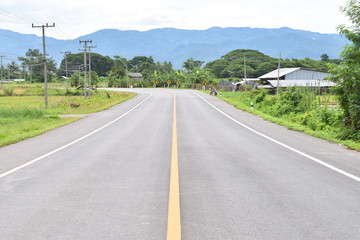 asphalt road through the countryside.