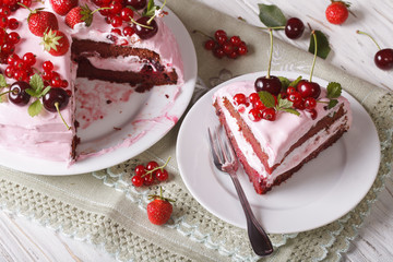 Homemade pink cake with fresh berries, sliced on a plate