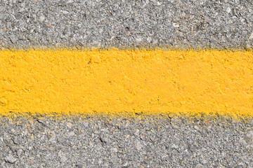 The yellow line of traffic on the road
