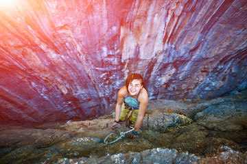 Rock climber climbing up a cliff