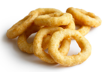 Heap of deep fried onion or calamari rings isolated on white.
