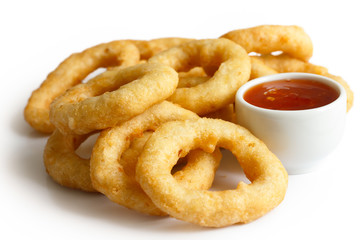 Heap of deep fried onion or calamari rings with chilli dip isola