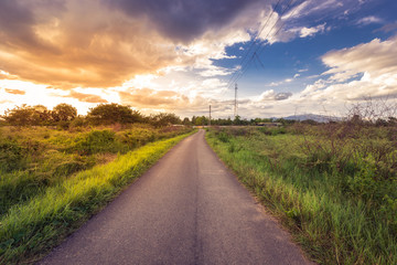 country road and field with beautiful sunset