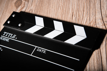 Obraz premium movie clapper on wooden background