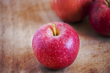 red apples on wooden table, selective focus