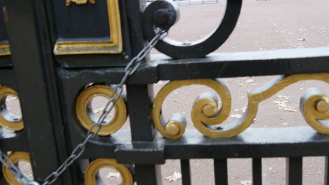 Buckingham Palaces gate with the padlock. The huge gate is locked for security