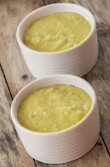 A bowl of thick, fresh, pea soup.