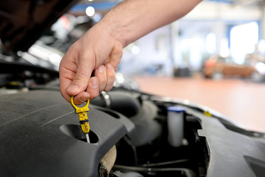 &Ouml;lstandskontrolle Motor beim Auto in einer KFZ-Werkstatt // checking the oil level in a car
