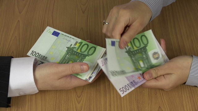 Illegal payment for work. Businesswoman hand pay euro cash money banknotes for man. Corruption concept. Shadow economy. Closeup shot. 4K UHD video clip.
