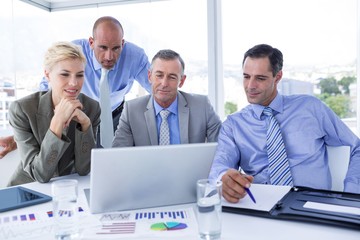 Business team working together on laptop