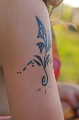 Mehendi tattoo on an woman's arm