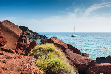 Beautiful Red Beach with turquoise water and big stones