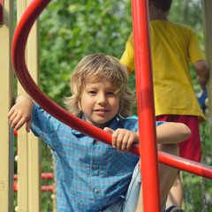 Fototapeta premium Cute young boy playing on playground.