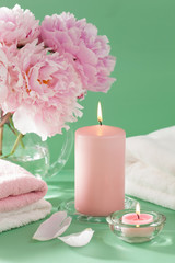 Obraz na płótnie Canvas bath and spa with peony flowers candles towels
