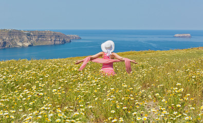 Woman in a long summer dress , on the beach sea.