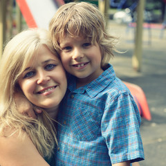 Portrait of happy mother and son in summer park, outdoor, toned