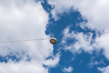 Outdoor hanging lamp on blue sky.