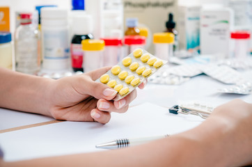 pharmacist preparing a prescription with different types of medicine 