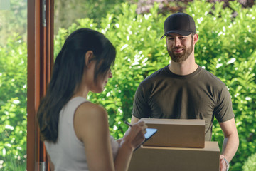 Woman accepting a delivery of two cardboard boxes