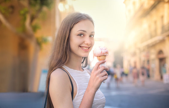 Smiling girl eating an ice cream