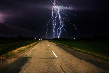 Lightning over asphalt road