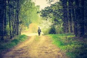 Man walking by forest path