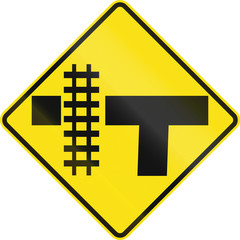 Warning road sign in Australia - Railroad crossing on the left