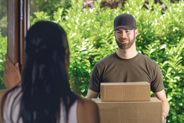 Woman answering the door to a deliveryman