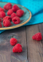 raspberries and mint leaves in a plate