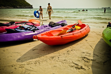 Colourful kayaks on the beach.