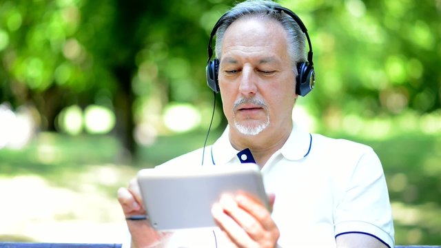 Man listening music in a park